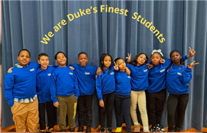  Students standing on the stage hugging and smiling with each others